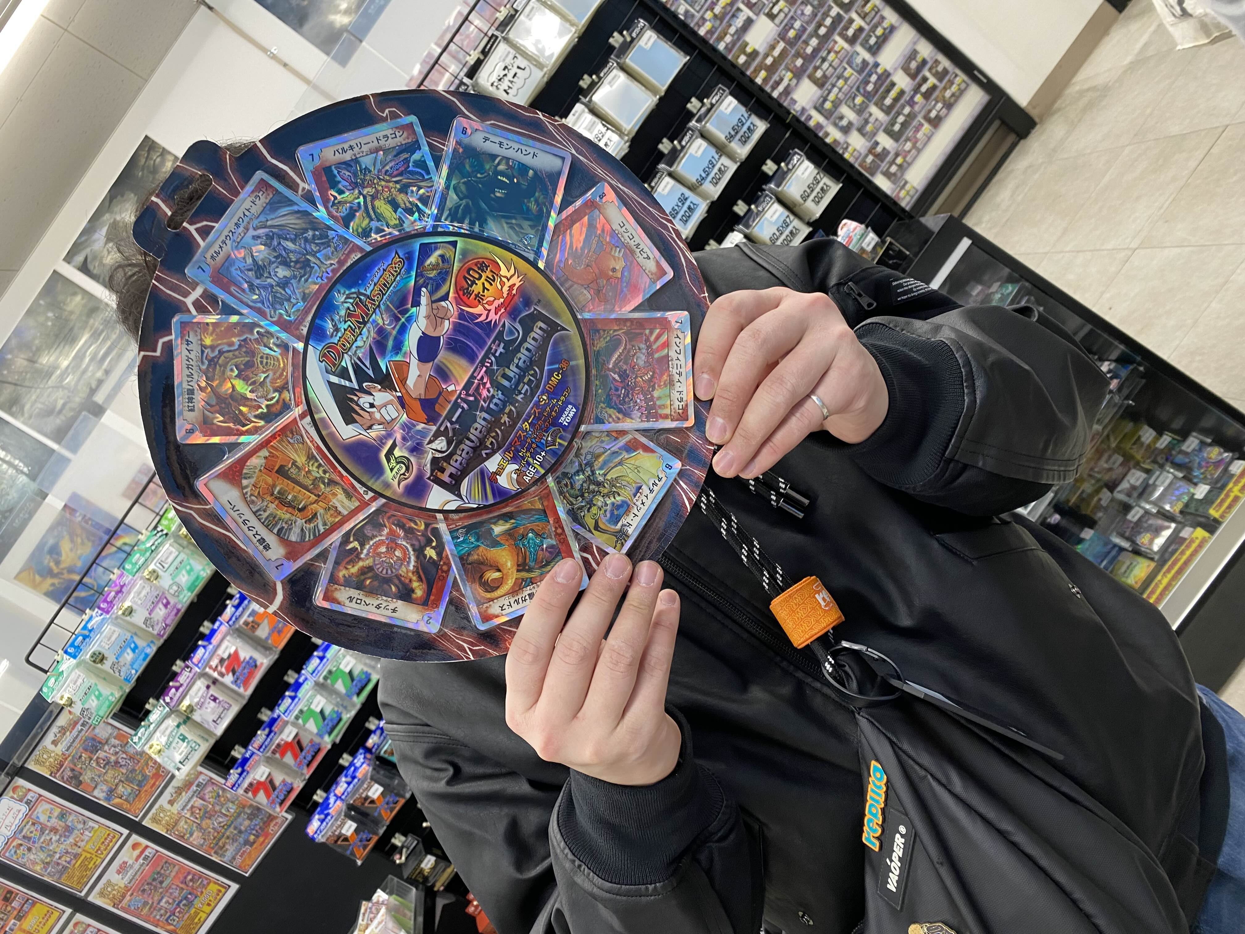 kenji holding a card display in the osaka shop
